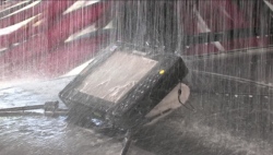 A tablet computer being subjected to water torture in a car wash.